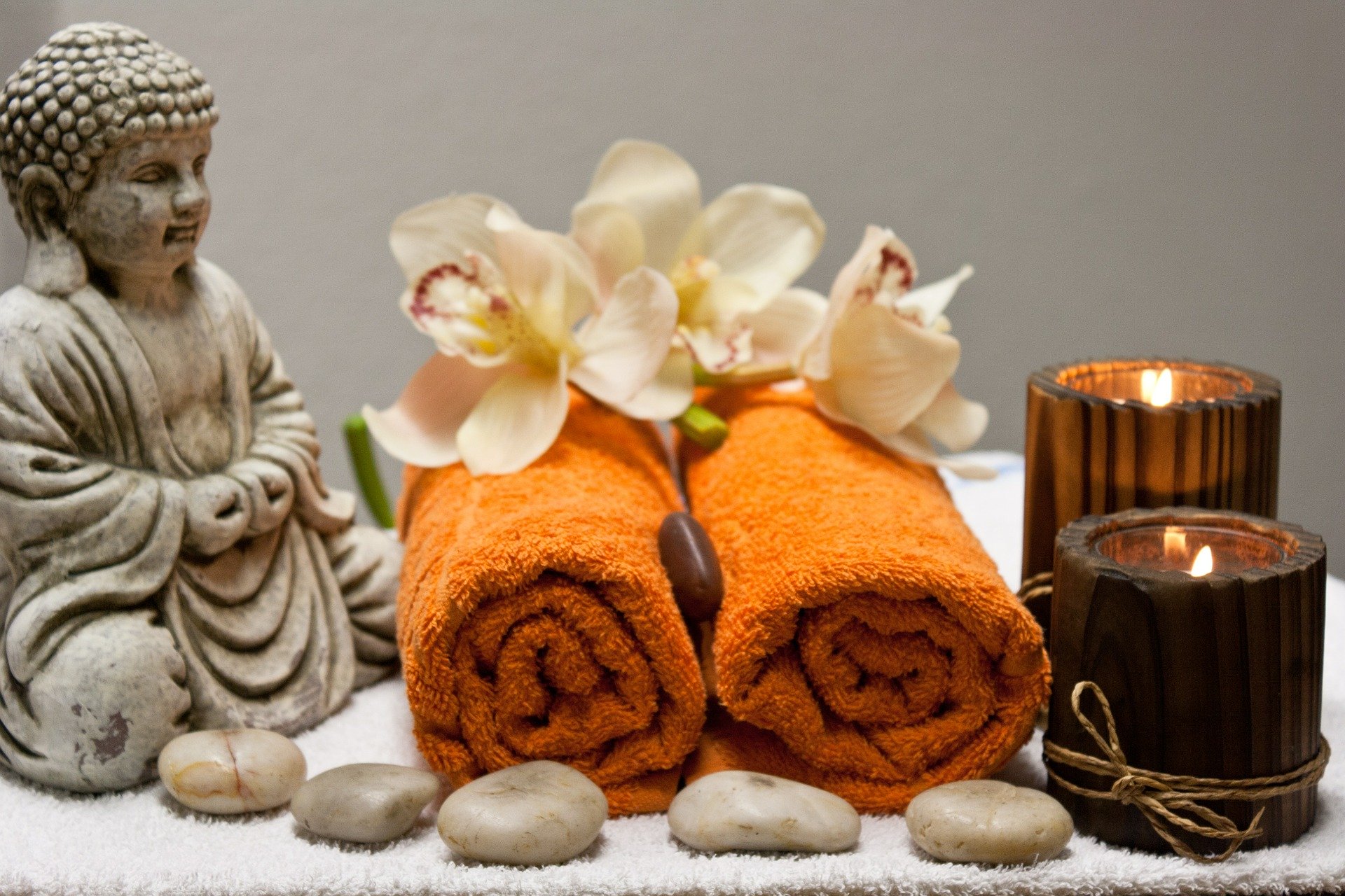 Mother's Day Jewellery Blog. A spa setting including candles, a buddha and warm towels.