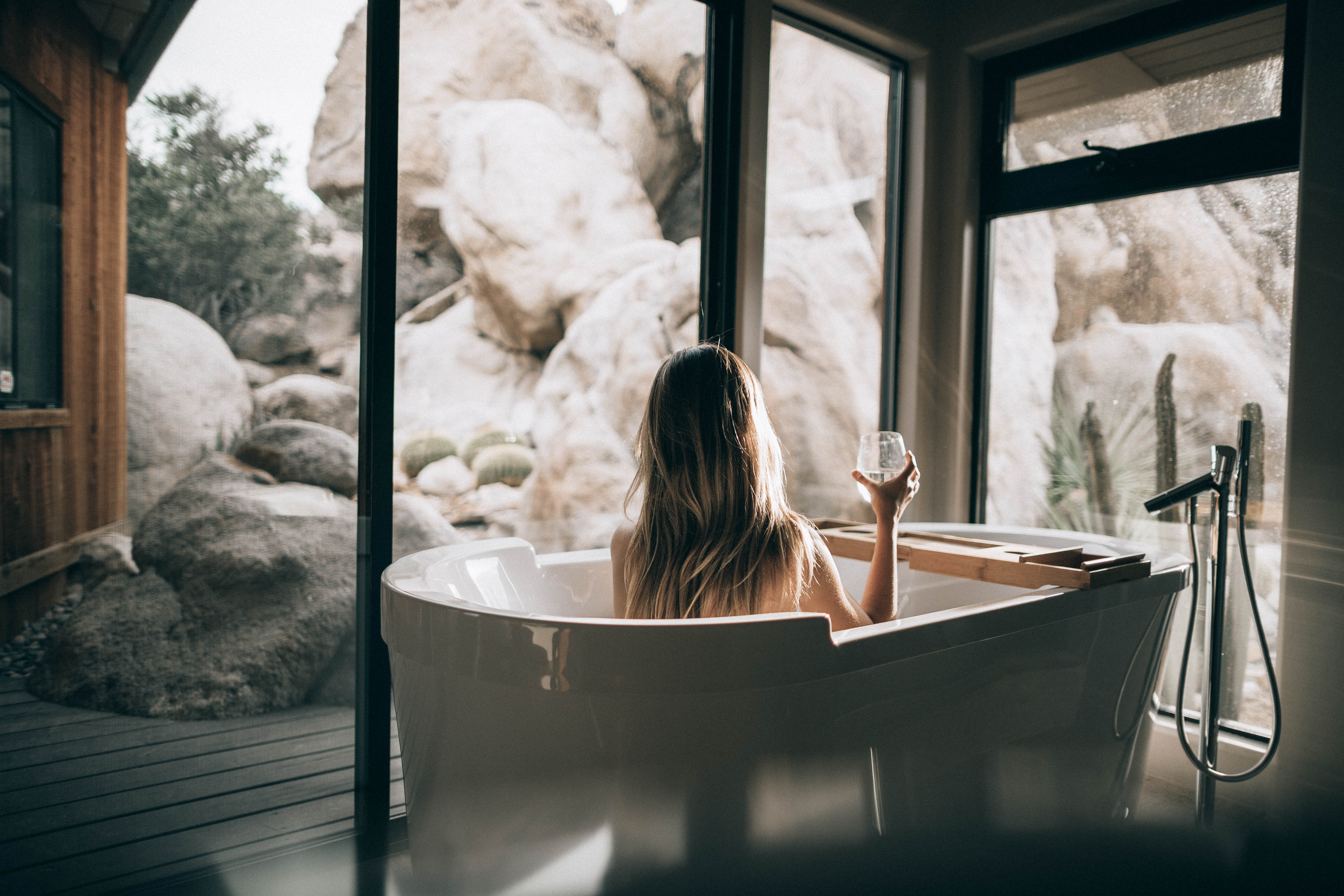 Woman Relaxing In a Bath with Glass of Wine 