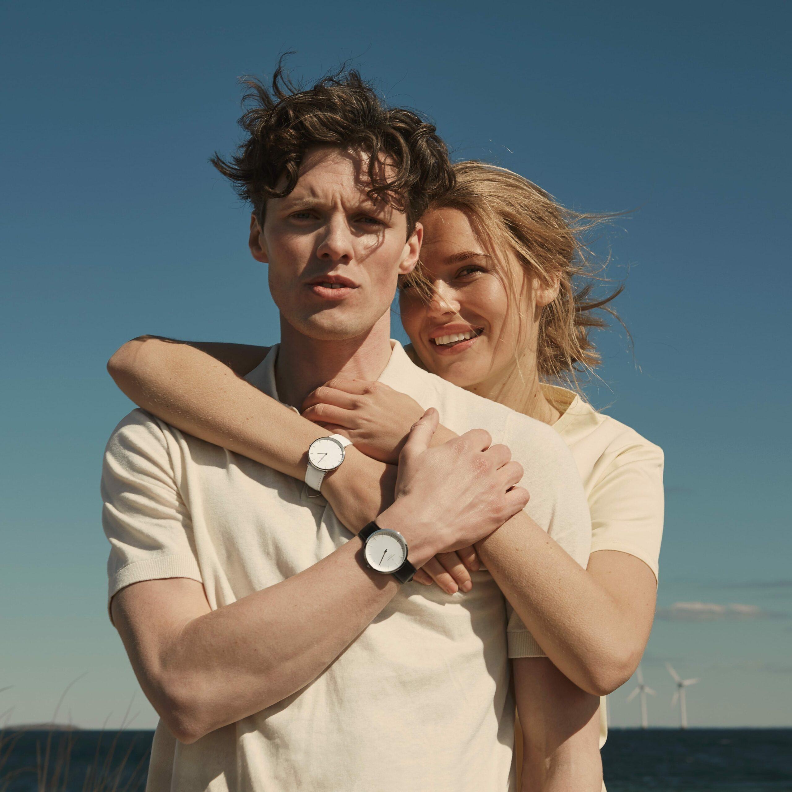 Nordgreen Male & Female Model Wearing Matching Watches While Hugging
