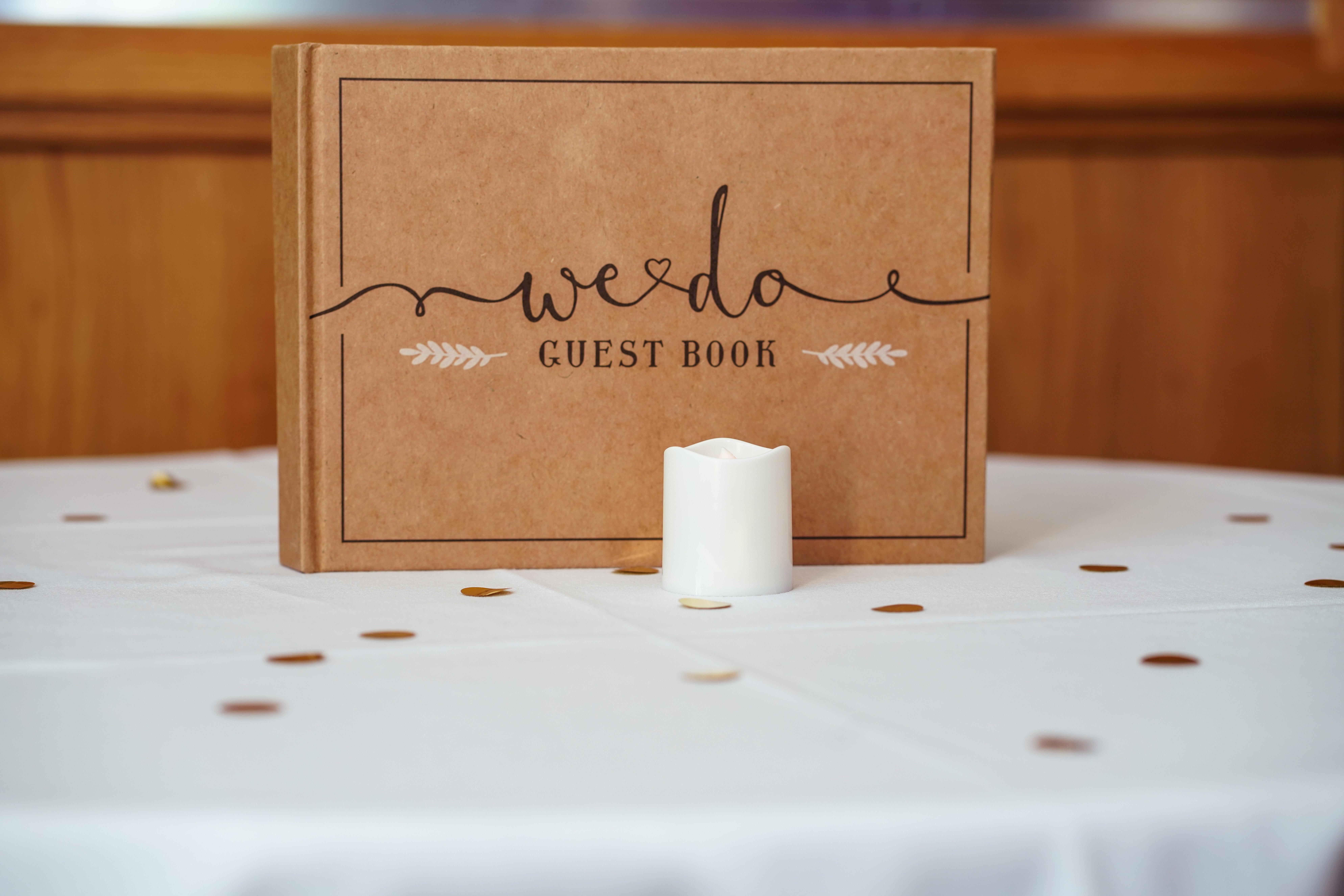 Brown Guest Book on White Table with Confetti