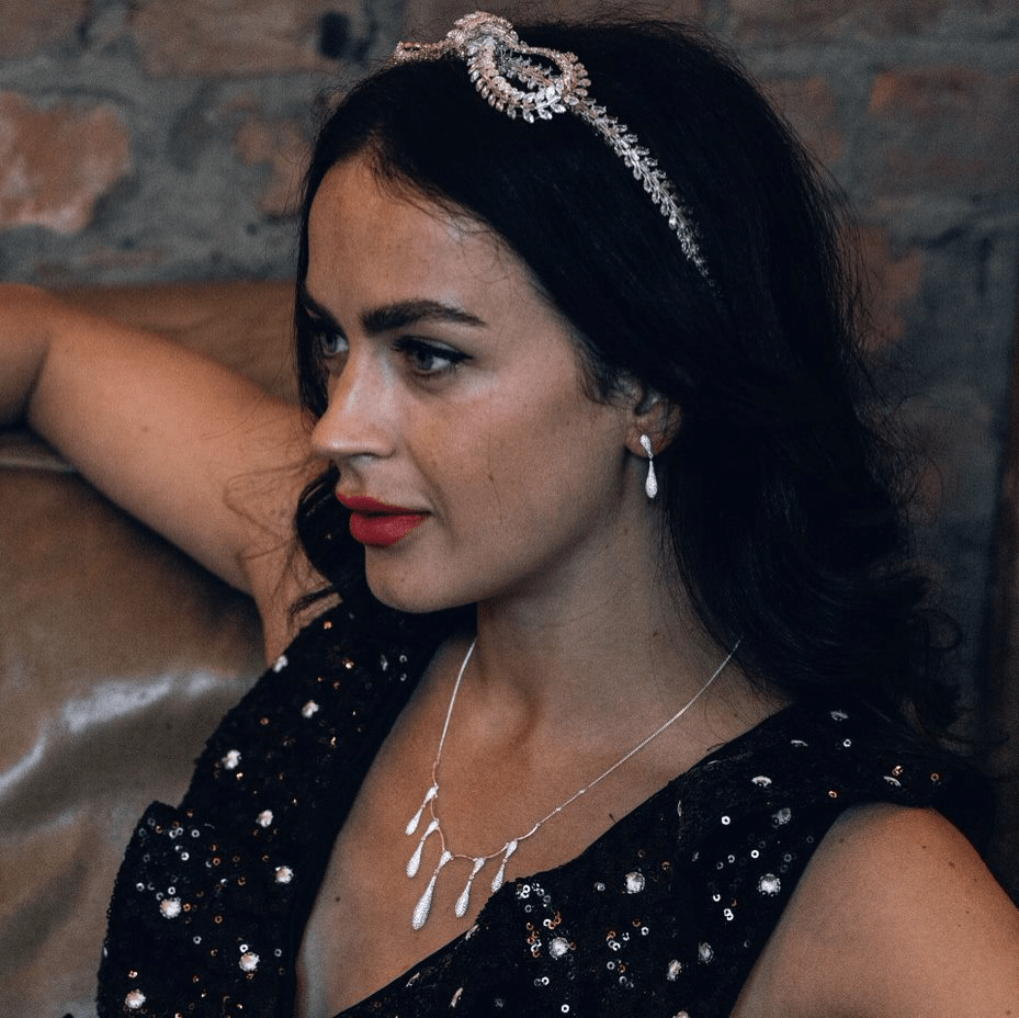 Slow Fashion Joshua James Jewellery Stardust Collection featured on a Woman. Bow headband, silver drop earrings and silver drop necklace.
