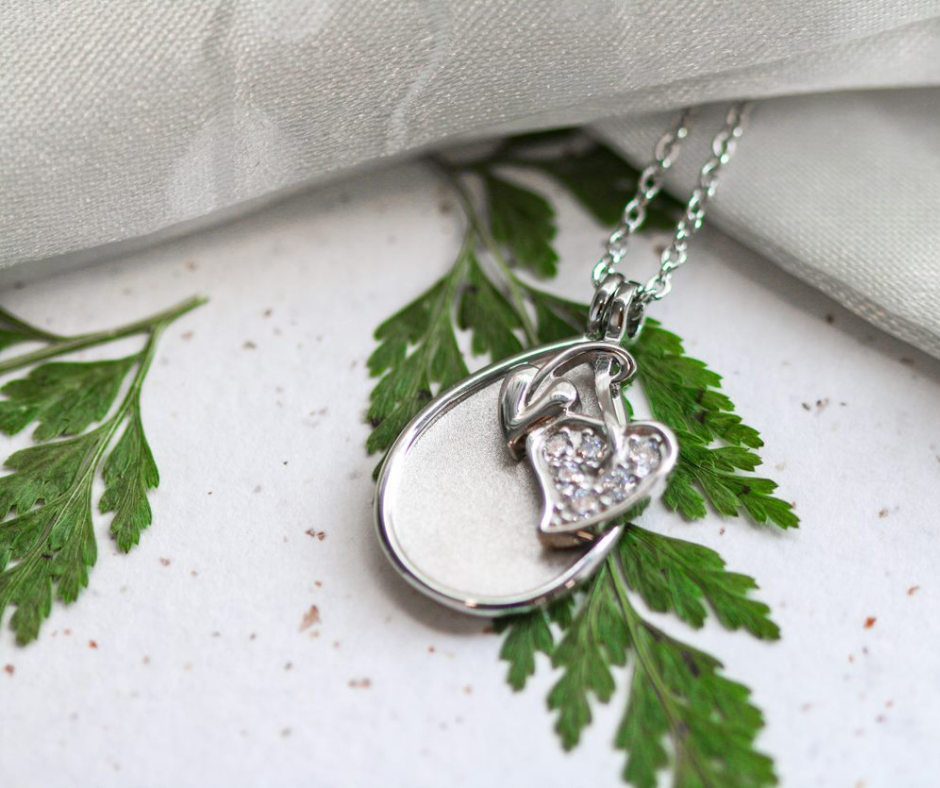 A Sacred Tree Pendant Laying On A Leaf